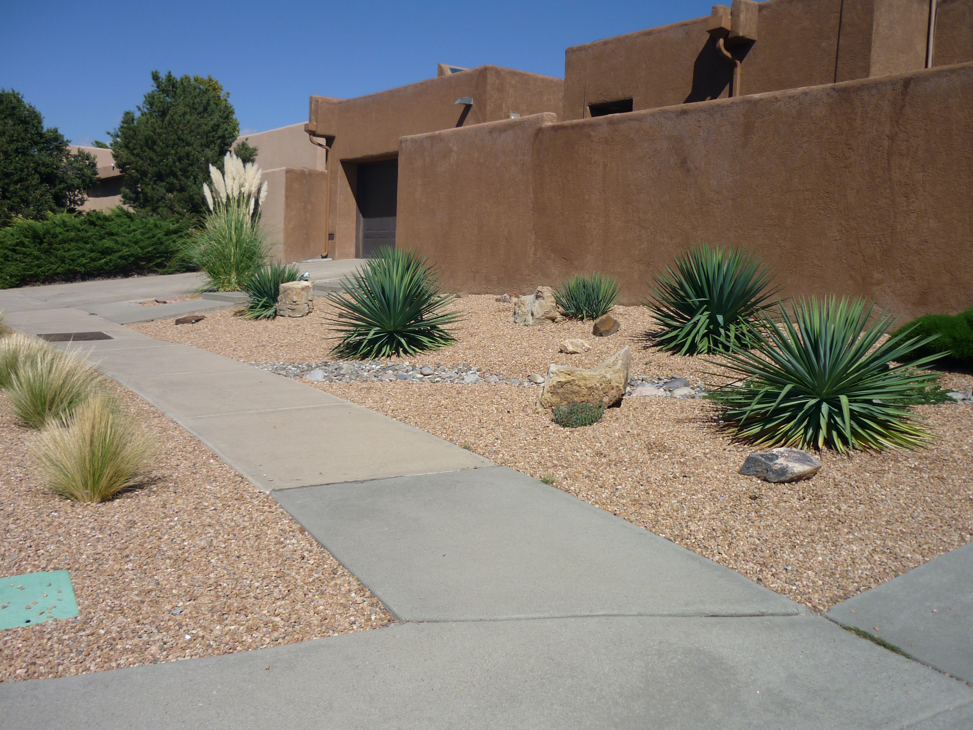 Southwestern adobe home with desert gravel landscaping